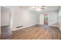 Spacious bedroom featuring wood-look floors, ceiling fan and neutral paint at 4442 Cedar Ridge Trl, Stone Mountain, GA 30083