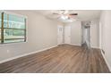 Bright living room features wood-look floors, large window, and modern ceiling fan at 4442 Cedar Ridge Trl, Stone Mountain, GA 30083