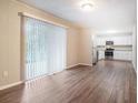 Open-concept living space featuring access to a kitchen with stainless steel appliances and white cabinets at 4442 Cedar Ridge Trl, Stone Mountain, GA 30083