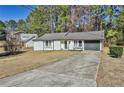 Charming single-story home with a driveway, neutral color, and well-maintained lawn at 3915 Basil Sw Way, Atlanta, GA 30331