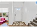 Bright entryway featuring a white front door with glass panes and a textured rug at 5780 Winding Lakes Dr, Cumming, GA 30028