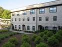 Attractive multi-story building with brick facade, well-maintained landscaping, and visible windows at 3411 Swallowtail Ter, Duluth, GA 30096