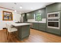 Modern kitchen features stainless steel appliances, olive green cabinets, and marble countertops at 3089 Ranlo Dr, Atlanta, GA 30340