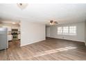 Bright and airy living room with hardwood floors open to a kitchen with stainless steel appliances at 3406 Blackberry Ln, Villa Rica, GA 30180