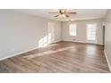 Spacious living room featuring hardwood floors, a ceiling fan, and plenty of natural light at 3406 Blackberry Ln, Villa Rica, GA 30180