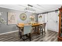 Inviting dining room with modern lighting and stylish decor with barn doors in view at 4648 Danna Dr, Austell, GA 30106