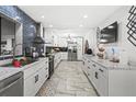 Bright kitchen with white cabinets, marble countertops, and stainless steel appliances at 4648 Danna Dr, Austell, GA 30106