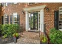 Elegant front entrance features brick steps, black railings, and a glass-paned front door with sidelights at 4971 Fairhaven Ne Way, Roswell, GA 30075