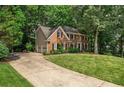 Charming brick residence features a well-manicured lawn, attached garage, and inviting curb appeal at 4971 Fairhaven Ne Way, Roswell, GA 30075