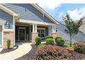 Charming front porch with stone pillars and cozy landscaping, creating a welcoming entrance at 5714 Pickens Garden Ln, Powder Springs, GA 30127