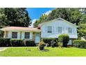 Charming home with white siding, well-manicured lawn, and mature trees providing ample shade at 8436 Magnolia Dr, Jonesboro, GA 30238