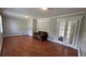 Cozy living room featuring laminate floors and decorative French doors at 8436 Magnolia Dr, Jonesboro, GA 30238