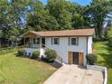 Stylish home featuring a whitewashed brick facade, a welcoming porch, and verdant landscaping at 1409 Georgia Ave, East Point, GA 30344