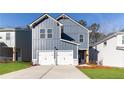 Charming two-story home with a two-car garage, modern siding, and a concrete driveway at 145 Weldon Rd, Mcdonough, GA 30253