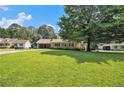 Single story home with a large front yard and covered carport, offering ample parking space at 338 Patterson Rd, Lawrenceville, GA 30044