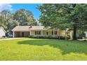 Charming single story home with a covered front porch and lush green lawn, great curb appeal at 338 Patterson Rd, Lawrenceville, GA 30044