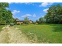 Expansive, lush green yard surrounding a charming home with ample space for outdoor activities at 1198 Old Mill Rd, Dallas, GA 30157