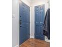 Stylish entryway with blue doors, modern hardware, and wood floors provides practical storage at 5149 Roswell Rd # 1, Atlanta, GA 30342