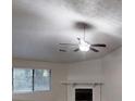 Bright living room with large windows, fireplace, and a ceiling fan creating a cozy atmosphere at 733 Emerald Forest Cir, Lawrenceville, GA 30044