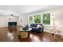 Spacious living room with hardwood floors, large windows, and a ceiling fan at 2483 Hunting Valley Dr, Decatur, GA 30033