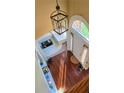 Bright foyer with hardwood floors, chandelier, and arched window allowing abundant natural light at 3310 Mcclure Woods Ct, Duluth, GA 30096
