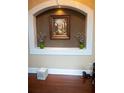 Nicely decorated wall niche and dark hardwood floors with dog sculpture in a room at 3310 Mcclure Woods Ct, Duluth, GA 30096