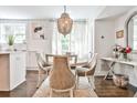 Bright dining area with a stylish chandelier, a round table, and views of the outdoors at 68 Peachtree Memorial Nw Dr # 68-5, Atlanta, GA 30309