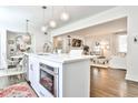 Open concept kitchen with a central island, stainless steel oven, and a seamless view into the living room at 68 Peachtree Memorial Nw Dr # 68-5, Atlanta, GA 30309
