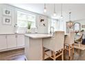 Well-lit kitchen with an island, pendant lights, and a view into the dining area at 68 Peachtree Memorial Nw Dr # 68-5, Atlanta, GA 30309