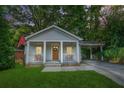 Charming craftsman home with a covered front porch and a convenient carport at 727 Holmes Nw St, Atlanta, GA 30318