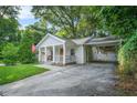 Charming craftsman-style home with covered front porch, carport, and mature trees at 727 Holmes Nw St, Atlanta, GA 30318