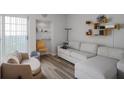 Inviting living room with stylish gray sofa and chairs, complemented by modern shelving and decor at 199 14Th Street Ne St # 2501, Atlanta, GA 30309