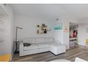 Comfortable living room with a sectional sofa, unique shelving, and views into the dining area at 199 14Th Street Ne St # 2501, Atlanta, GA 30309