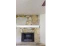 Close-up of the stone fireplace with a wooden mantle, adding rustic charm at 3136 Palomino Dr, Powder Springs, GA 30127