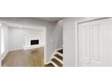A bright hallway with wooden floors, adjacent to a living room with a white-painted brick fireplace at 3695 Fox Hills Se Dr, Marietta, GA 30067