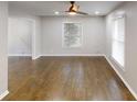 Bright living room with hardwood floors, a ceiling fan, and natural light streaming through the windows at 3695 Fox Hills Se Dr, Marietta, GA 30067