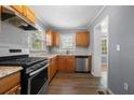 Bright kitchen with stainless steel appliances, hardwood floors, and light wood cabinets at 1472 Norman Berry Dr, Atlanta, GA 30344