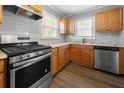 View of the spacious kitchen featuring stainless steel appliances and light wood cabinetry at 1472 Norman Berry Dr, Atlanta, GA 30344