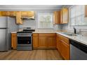 Updated kitchen with stainless steel appliances, light-wood cabinets, and lots of countertop space at 1472 Norman Berry Dr, Atlanta, GA 30344
