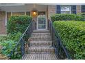 Inviting front entrance with brick steps and wrought iron railings framed by lush greenery at 2286 Capehart Ne Cir, Atlanta, GA 30345