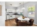 Bright kitchen with white cabinets, granite countertops, modern appliances, and a cozy dining area at 4457 Watson Ridge Dr, Stone Mountain, GA 30083