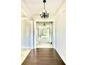 Inviting entryway showcasing hardwood floors and an elegant chandelier highlighting the home's open layout at 5599 Wheeler Ridge Rd, Auburn, GA 30011
