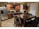 Cozy eat-in kitchen featuring stainless steel appliances and wood cabinets with a dining table for four at 5626 Laurel Ridge Dr, Atlanta, GA 30344