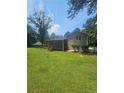 Expansive backyard showcasing a screened porch perfect for outdoor relaxation at 7562 Asbury Manor Dr, Lithonia, GA 30014
