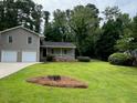 Well-maintained home with a spacious front yard and a classic architectural design at 7562 Asbury Manor Dr, Lithonia, GA 30014
