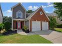 Charming two-story home featuring a brick and siding exterior, well-kept lawn, and a two-car garage at 1265 Birchwood Ln, Roswell, GA 30076