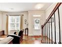 Bright foyer with hardwood floors, staircase, and ample natural light, creating a warm and inviting entrance at 2325 Lake Cove Ct, Buford, GA 30519