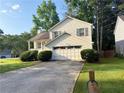 Attractive house with an attached garage, complemented by lush green lawn at 2765 Dahlonega Trl, Austell, GA 30106