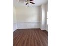 Cozy living room with wainscoting and rich hardwood floors at 5890 Crowley Dr, Douglasville, GA 30135