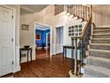 Inviting foyer with hardwood floors, staircase, and views into other rooms at 10575 Tuxford Dr, Alpharetta, GA 30022
